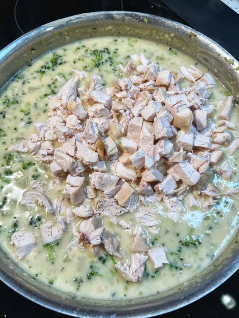 Diced chicken added to a creamy base of potatoes and broccoli for pot pie.