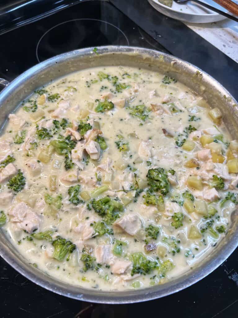 A creamy sauce base for Broccoli Chicken Pot Pie in a pan.