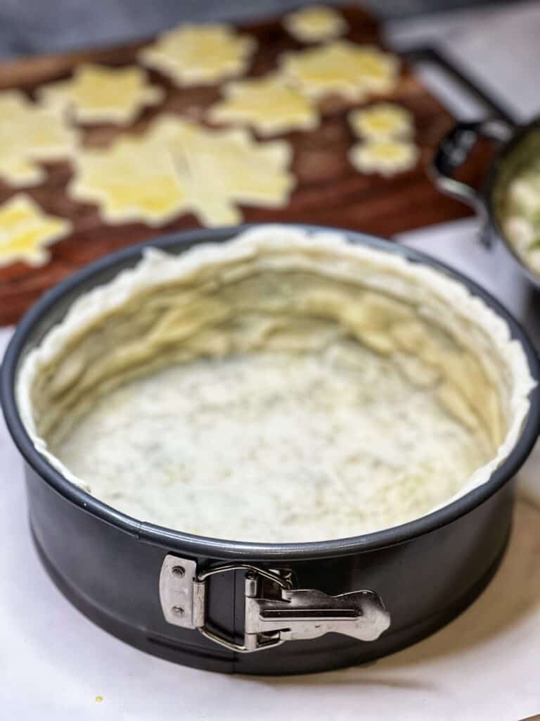 Pastry dough that has been formed into a springform pan and par-baked for a few minutes.