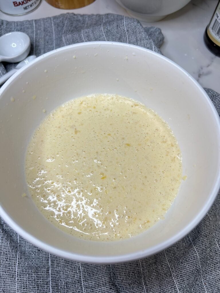 Wet mixture in a white bowl for pancakes.