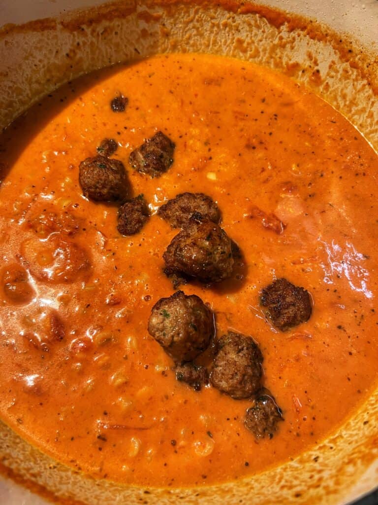 Meatballs added to creamy soup base.