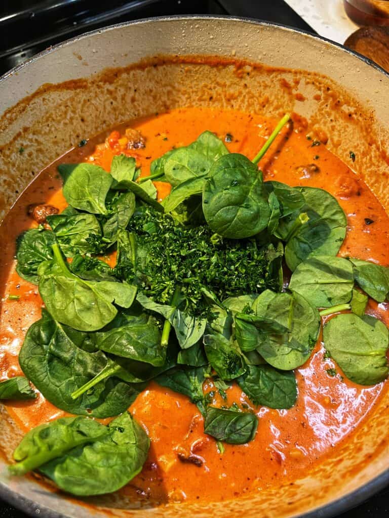 Fresh baby spinach and herbs added to creamy meatball soup.