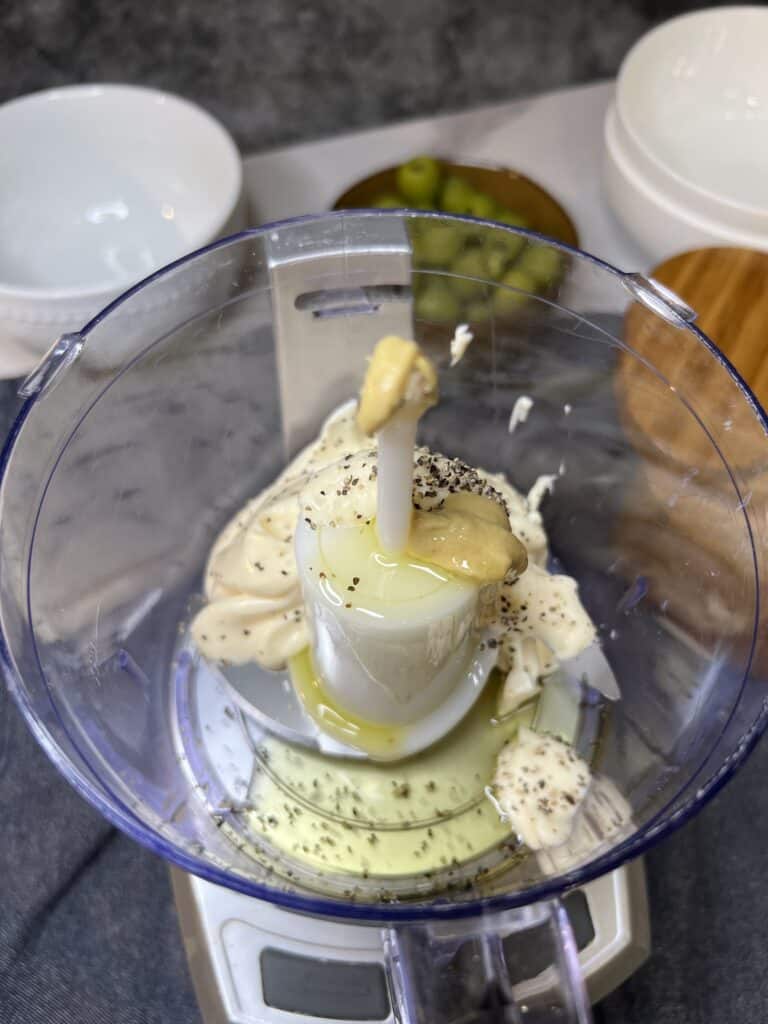 Mayo, garlic, olive oil, Dijon, salt and pepper in a small food processor.