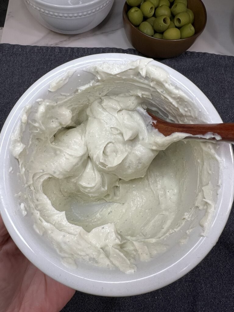 Ricotta and blue cheese creamed together in a white bowl.