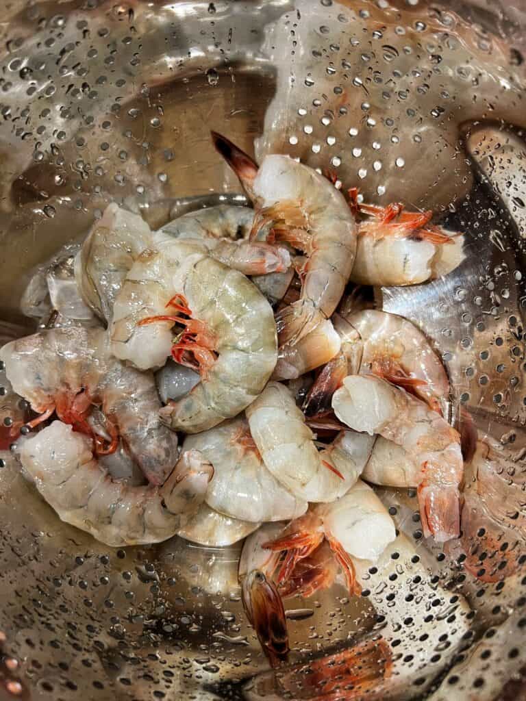 A colander full of wild-caught North Carolina shrimp with the shell-on.