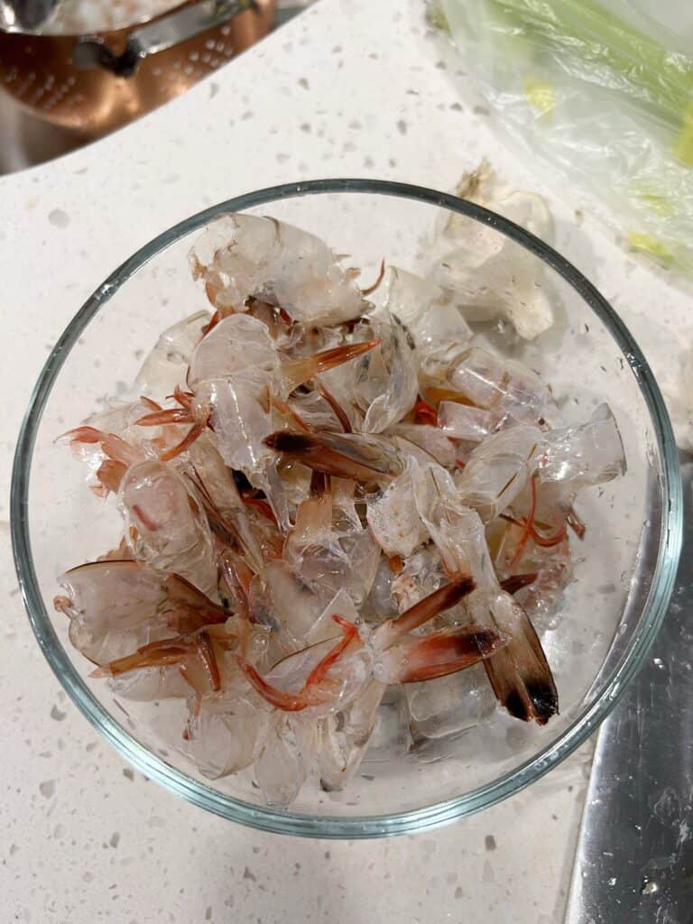 A glass bowl containing shrimp shells.