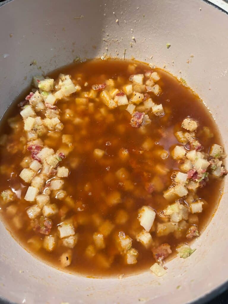 Shrimp stock added to diced potatoes and diced bacon for Shrimp and Corn Chowder.