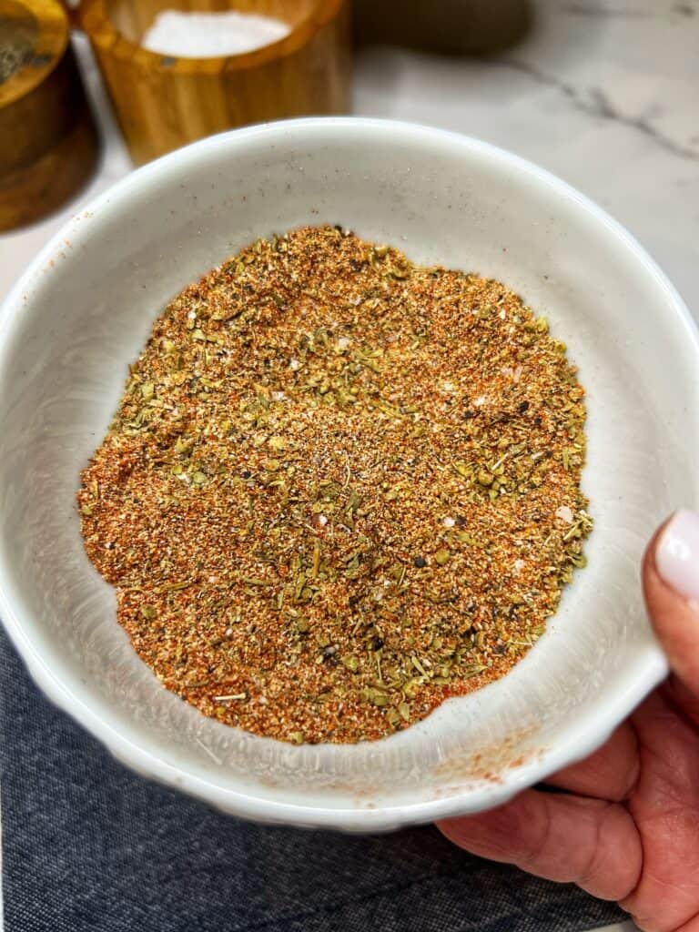 A small white bowl filled with blackening seasoning.