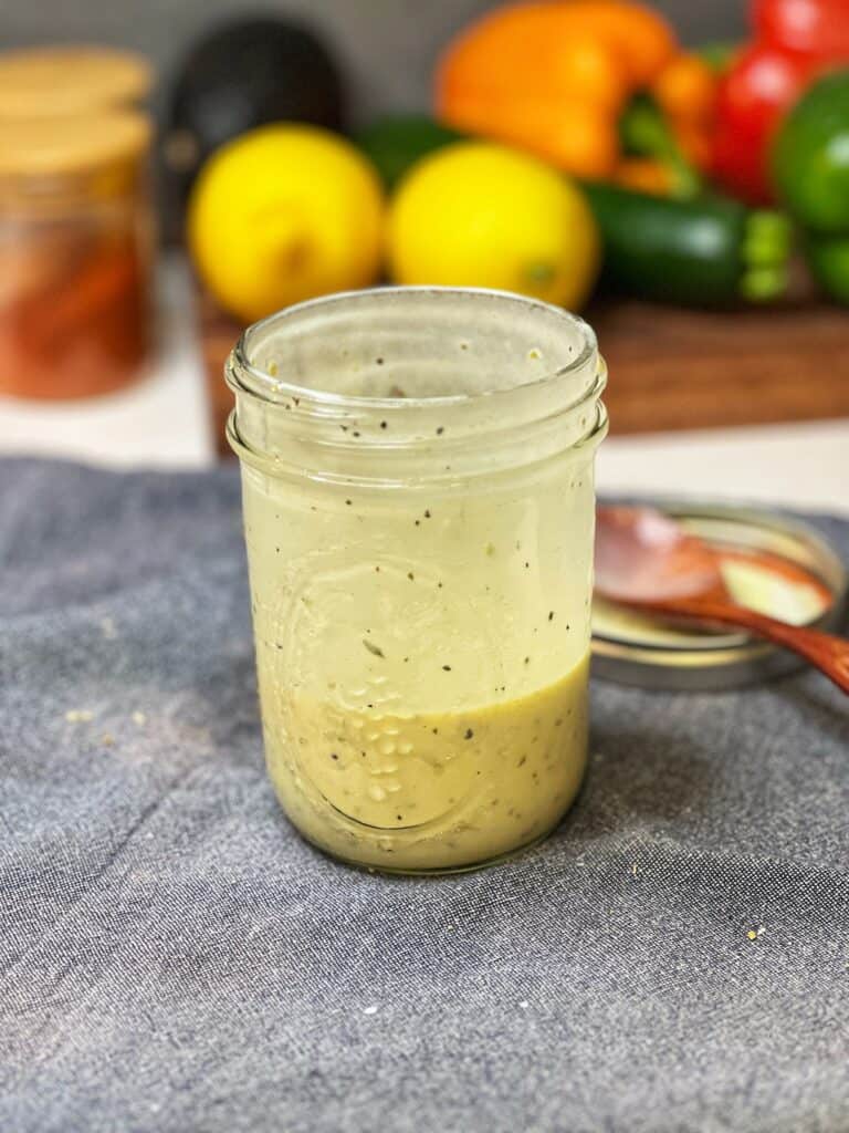 Creamy Greek Dressing mixed up in a Mason jar for Greek Chicken Rice Bowls.