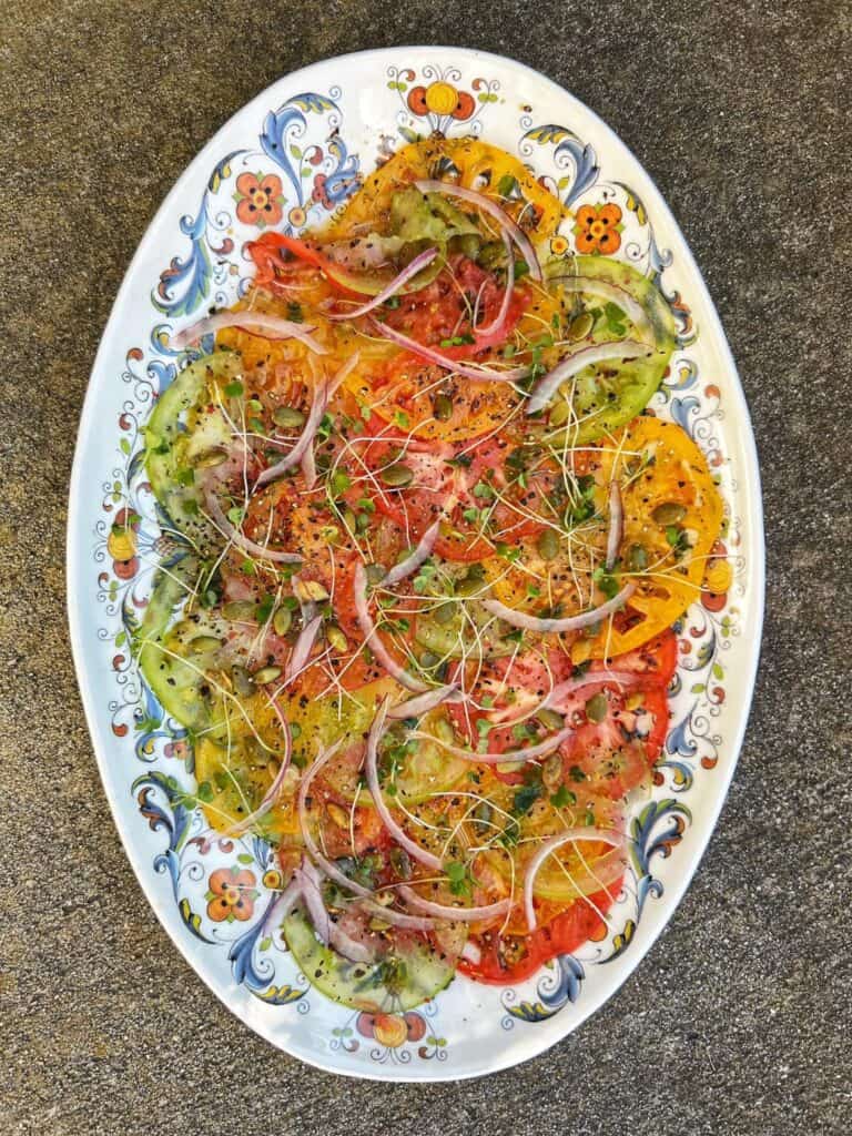 A overhead view of an Heirloom Tomato Carpaccio Salad.