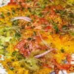 A close up of an heirloom tomato carpaccio salad.