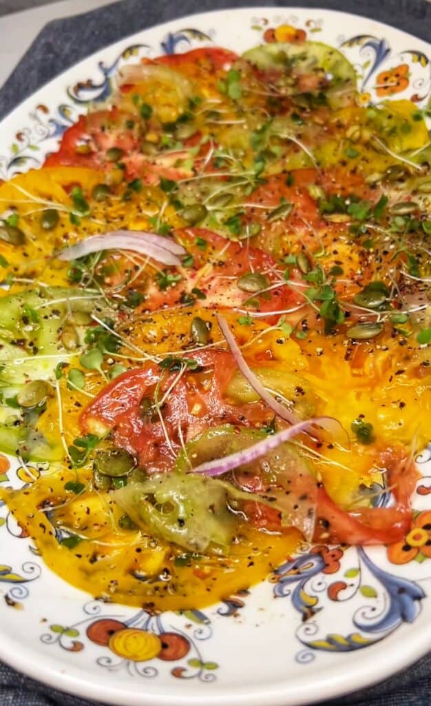 A close up of an heirloom tomato carpaccio salad.
