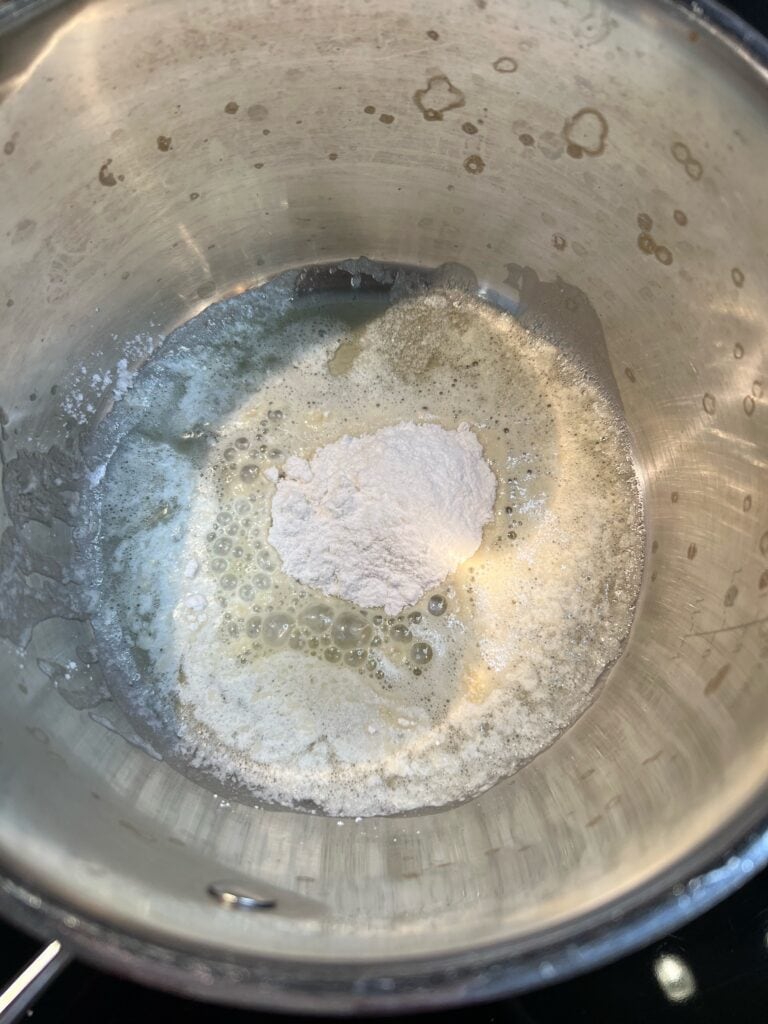 Melted butter and flour in a saucepan for homemade cheese sauce.