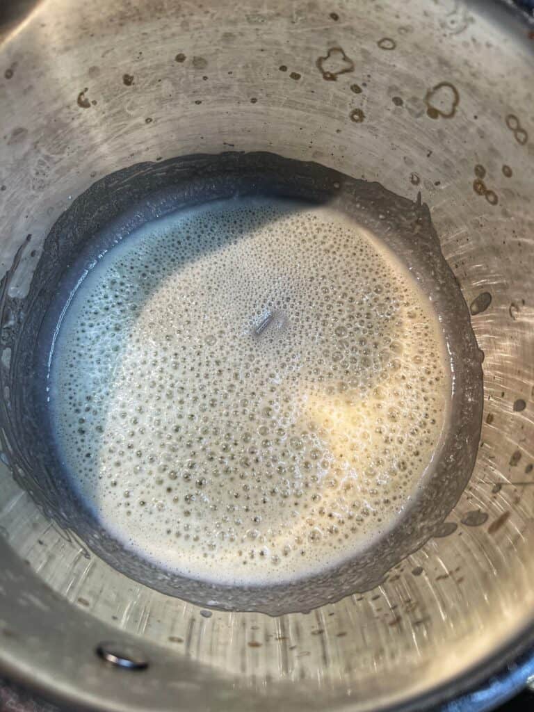 Flour and butter mixture cooking in a saucepan.
