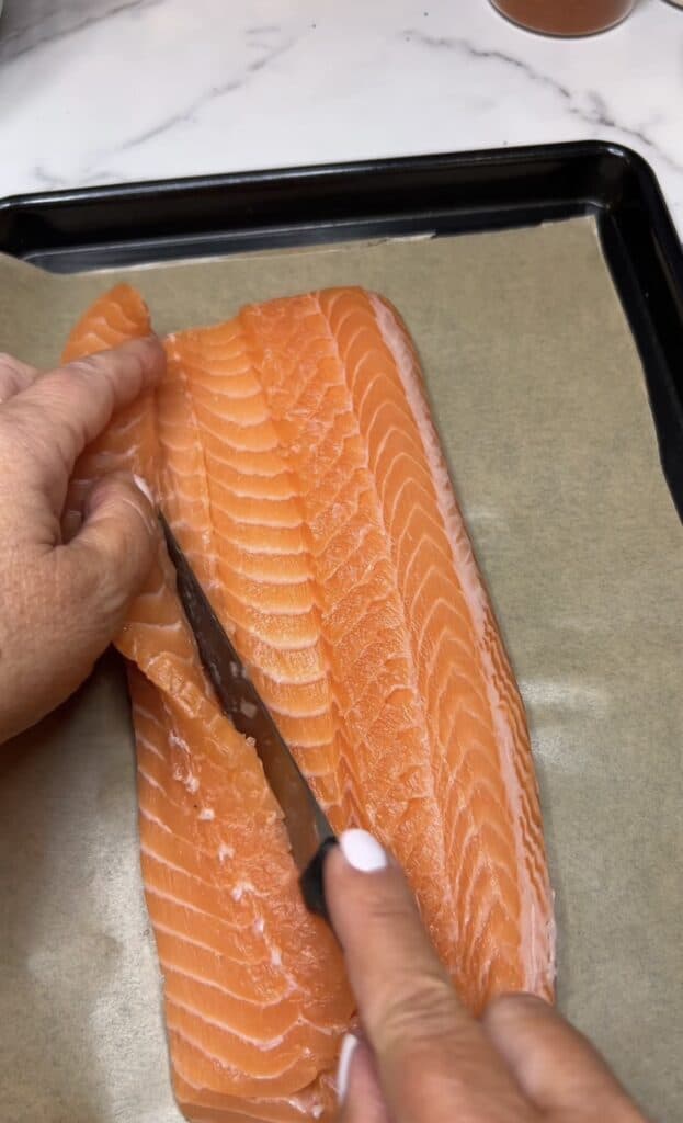 Cut flap of a salmon filet is opening.