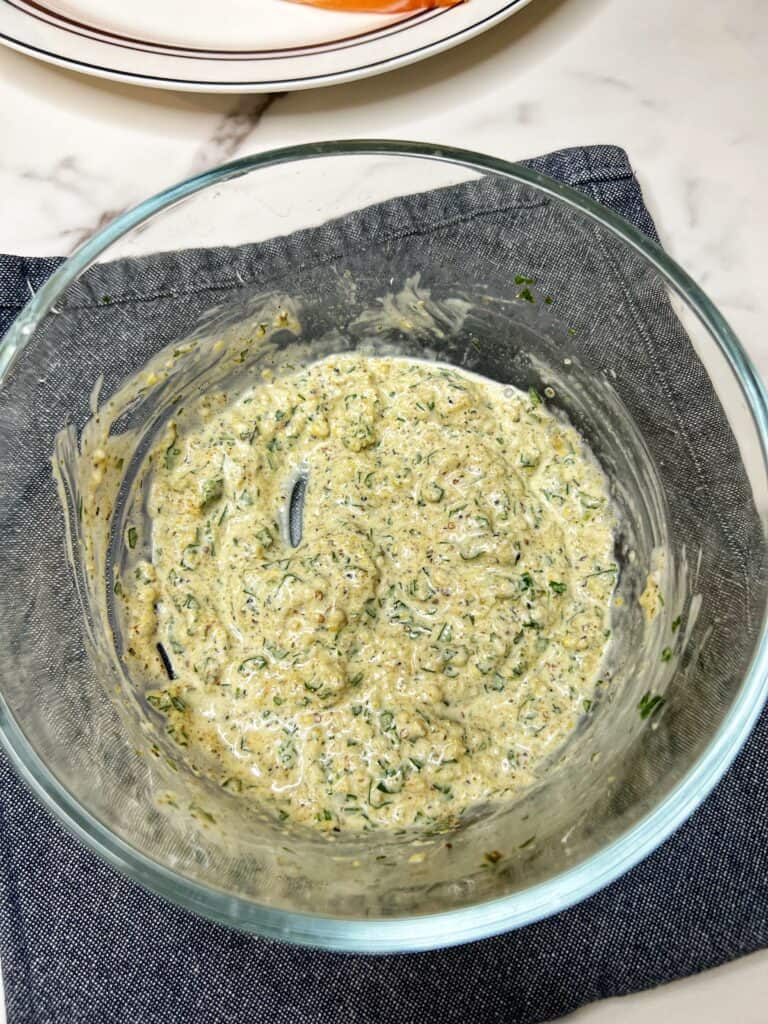 A creamy base in a small glass bowl for crabmeat stuffing.