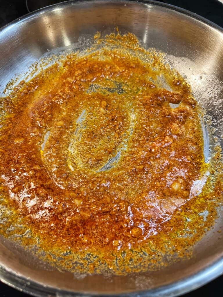 Cajun spices toasting in a wine redution.