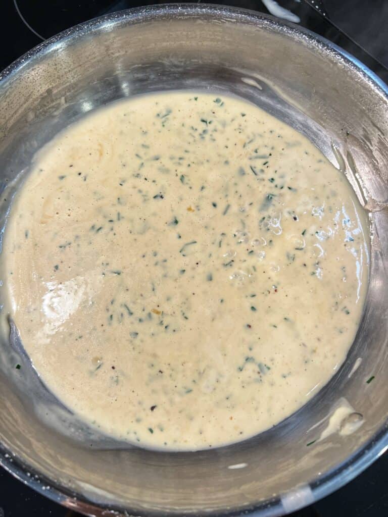 A stainless steel pan of Dijon Cream Sauce.