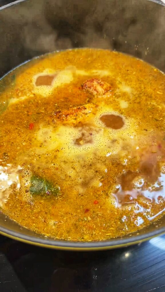 Simmering soup base for Creamy Chicken Noodle Soup.