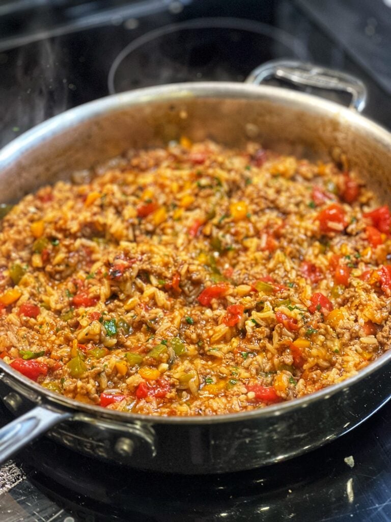 Ground Beef and Rice Skillet in a pan with bell peppers, ground beef and rice in a tomatoey sauce.