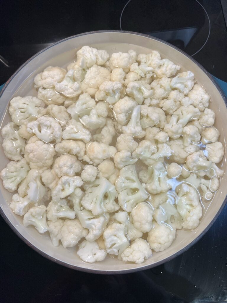Cauliflower florets boiling in water.