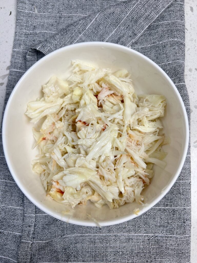A bowl of Dungeness crabmeat that has been removed from its shell. 