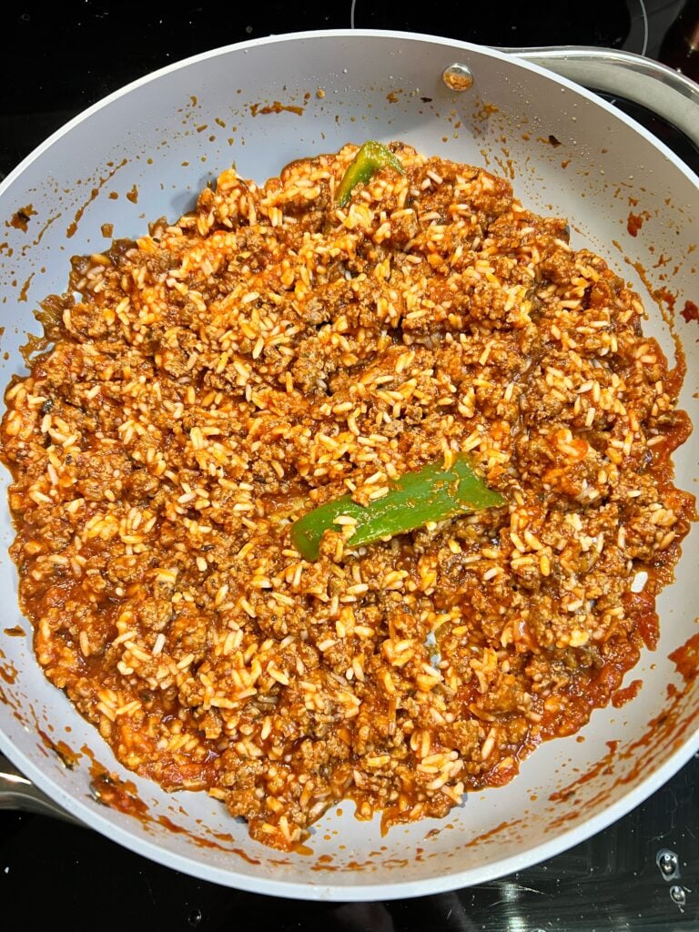 A tomato beef rice mixture in a pan.