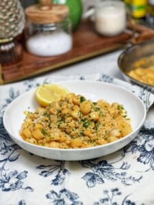 Creamy Cajun bay scallops on a bed of rice. The sauce has an orangish-hue.